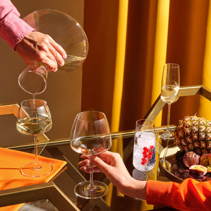 An elegant display of the Mirage crystal glassware collection including wine glasses, highball glasses, and a decanter.