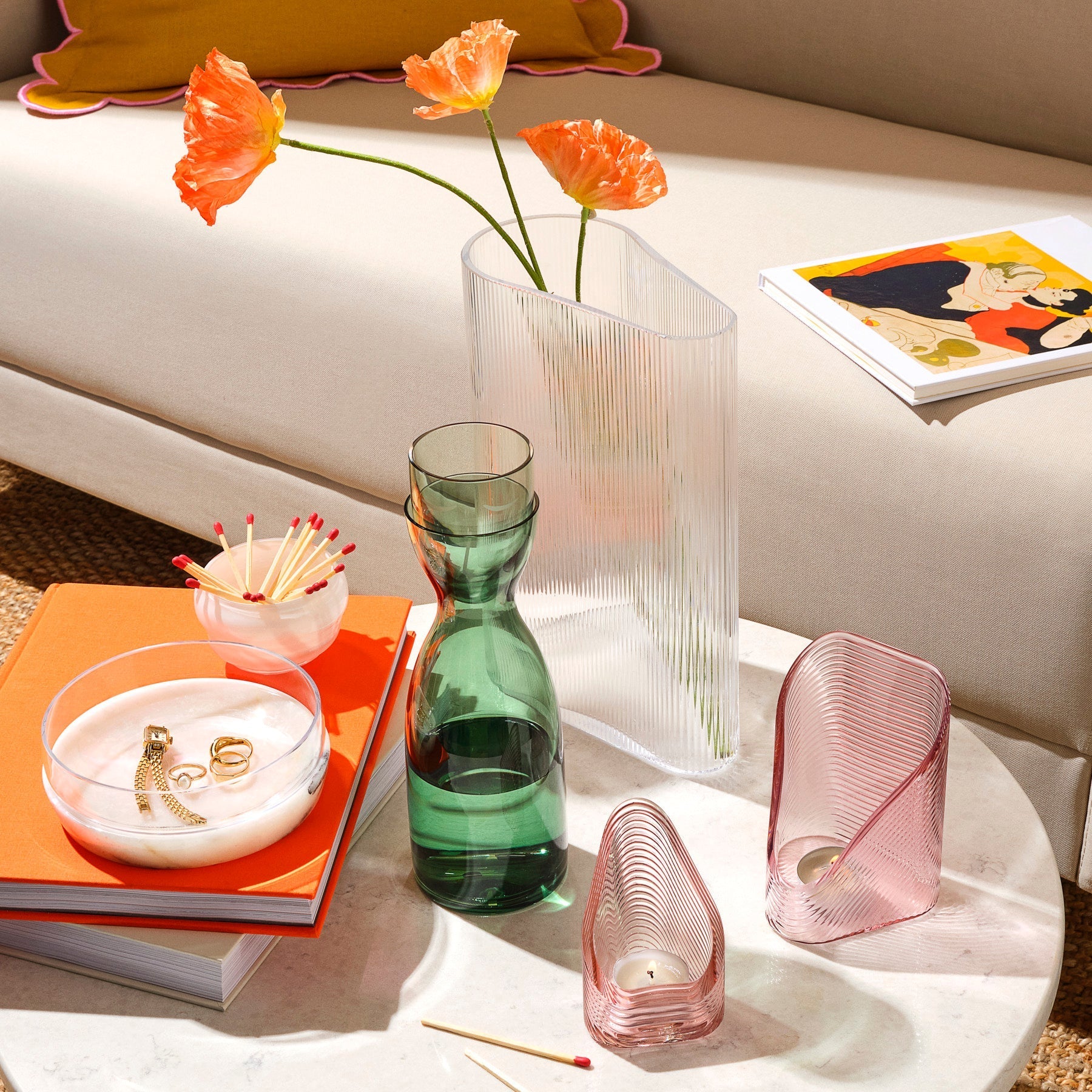 Curated display of modernist glassware including a crystal vase and Chill bowl