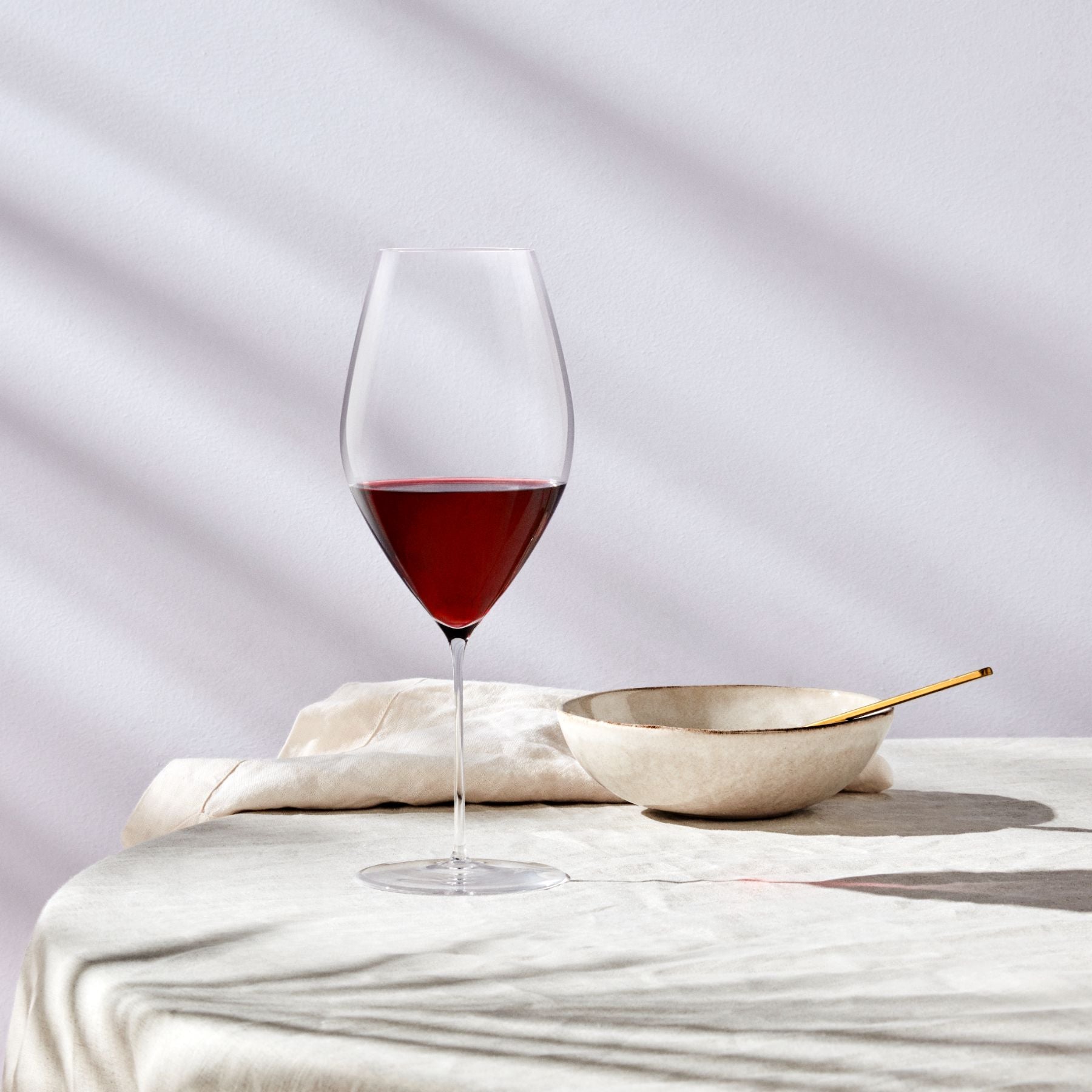 Close-up detail of the delicate rim and exquisite craftsmanship of the NUDE Glass Stem Zero Grace Red Wine Glass.