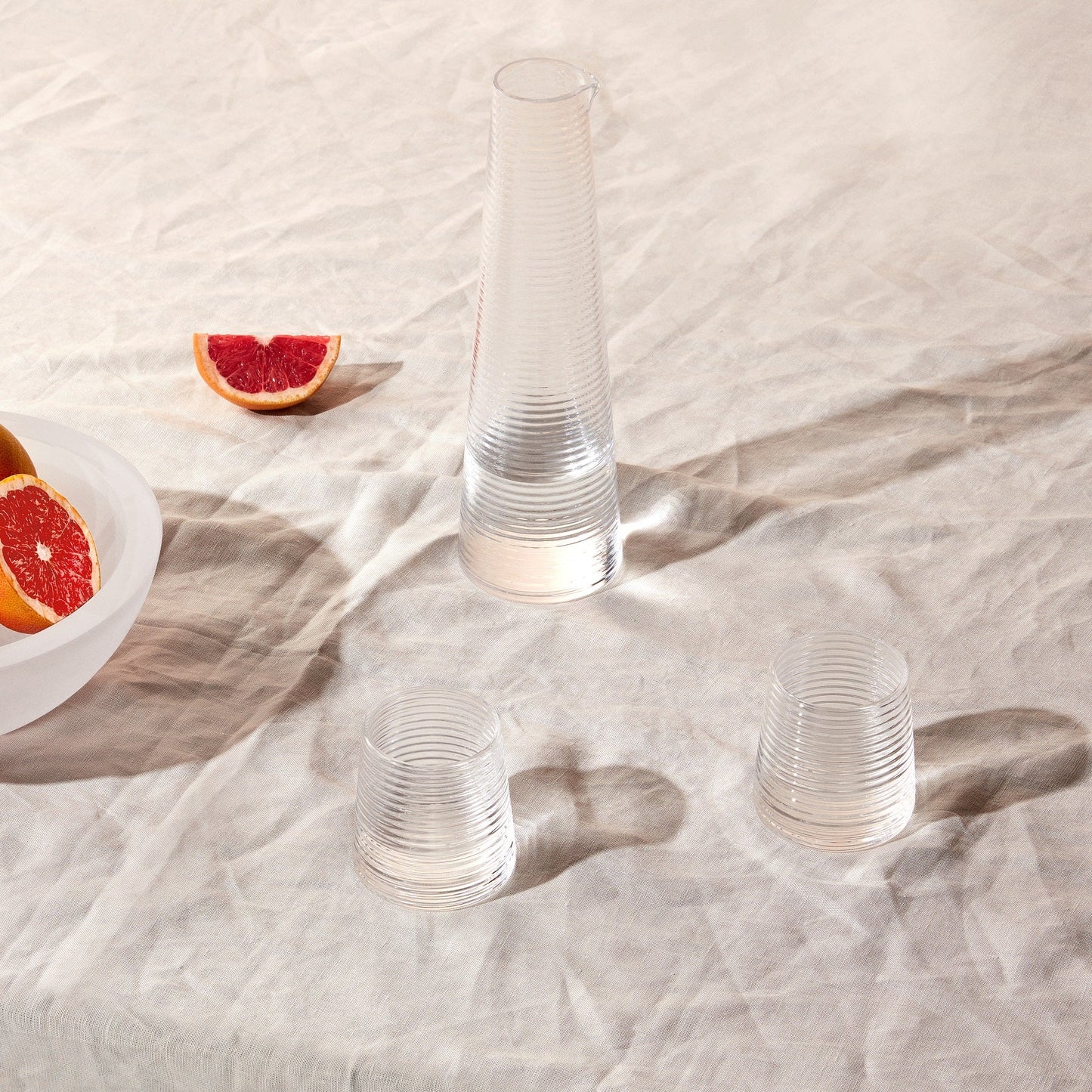Two elegant NUDE Glass Poem crystal water glasses displayed together, highlighting their architectural form.