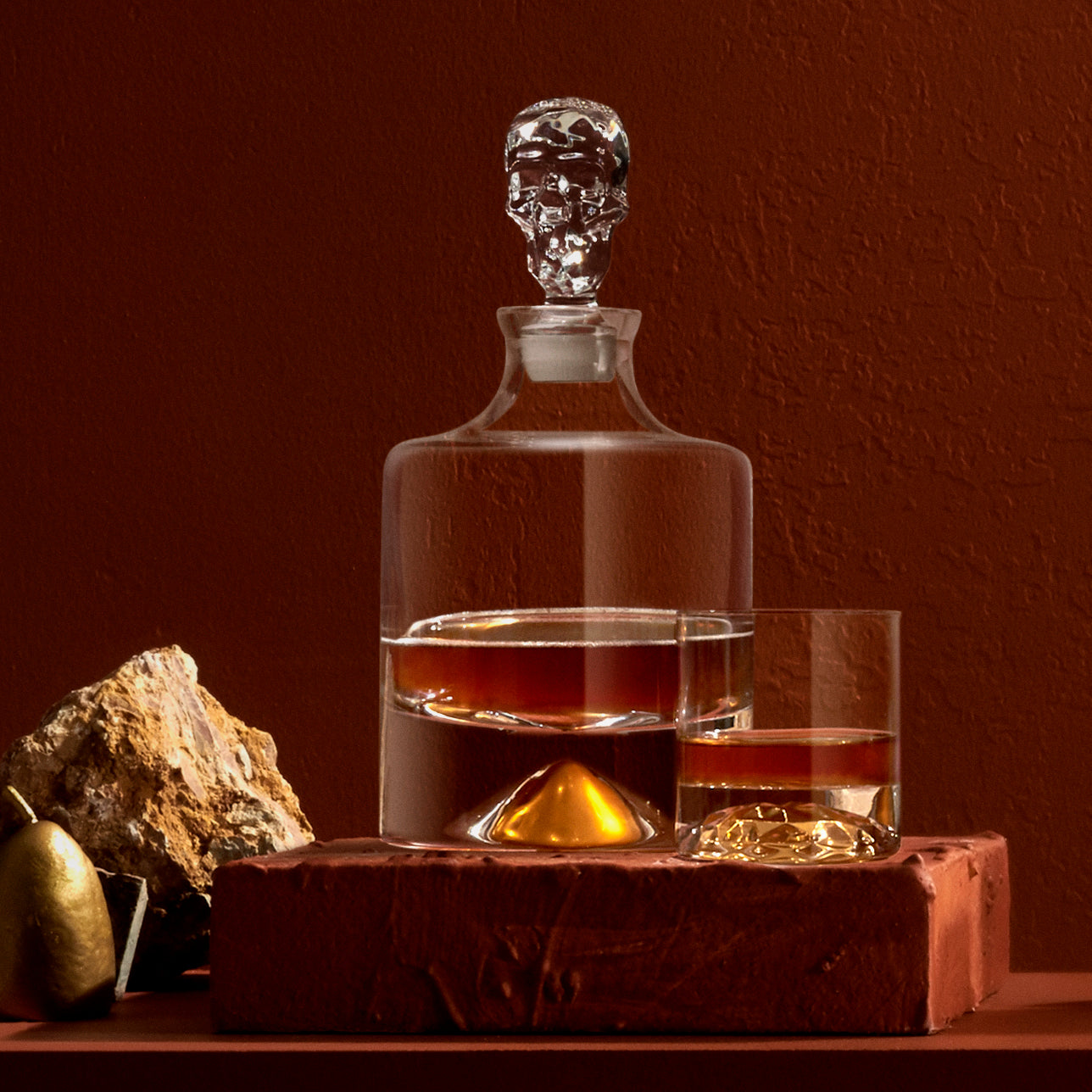 The NUDE Glass Shade crystal decanter filled with whisky on a contemporary bar surface