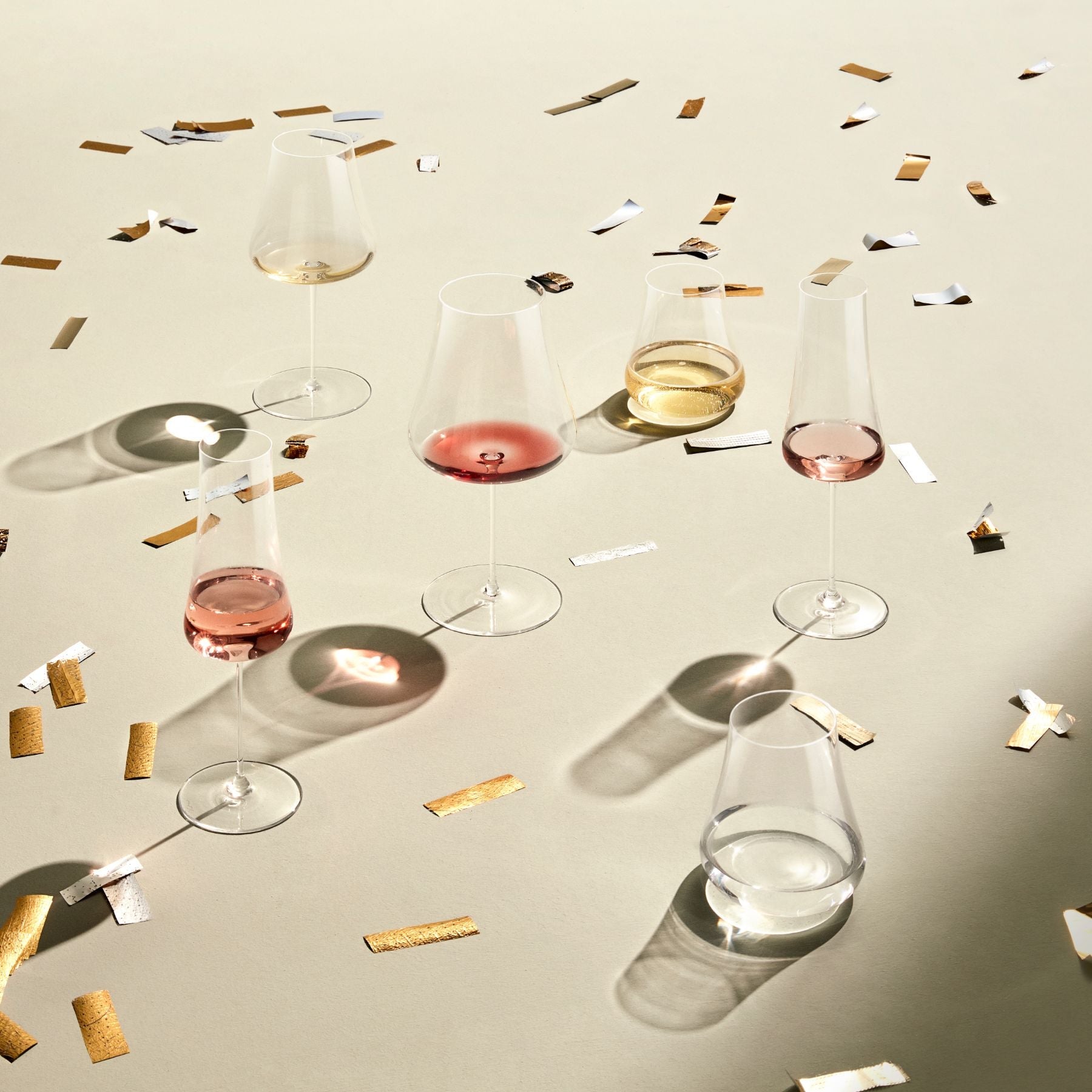 A close-up view of wine being poured into a delicate NUDE Glass Stem Zero Volcano lead-free crystal glass.