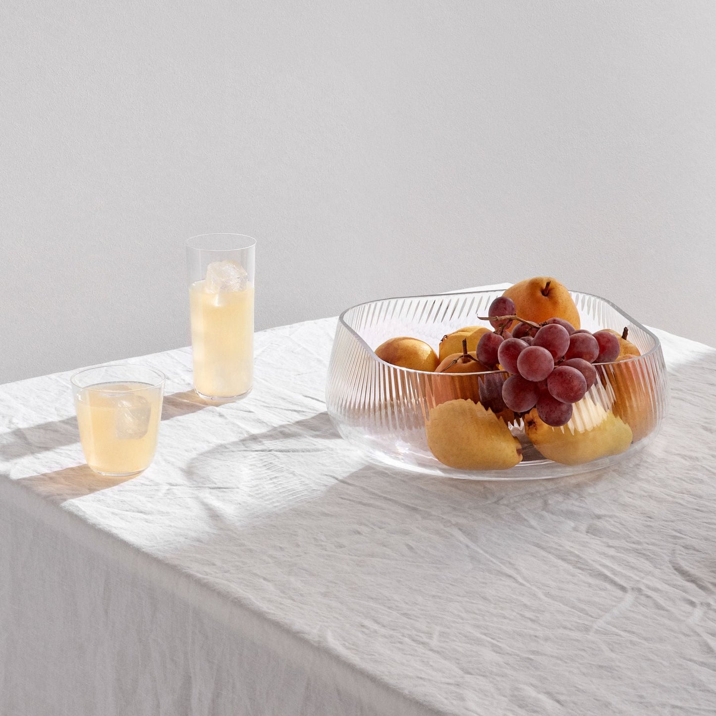 Sculptural ribbed crystal centerpiece styled as a modernist fruit bowl on a dining table