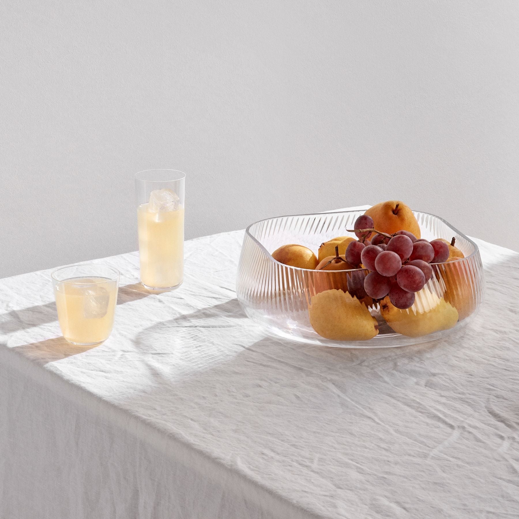 Sculptural ribbed crystal centerpiece styled as a modernist fruit bowl on a dining table