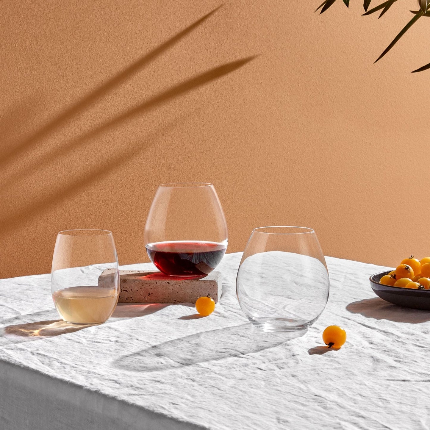 Sophisticated modern dining table styled with clear NUDE Glass Pure Bourgogne glasses for a formal dinner.