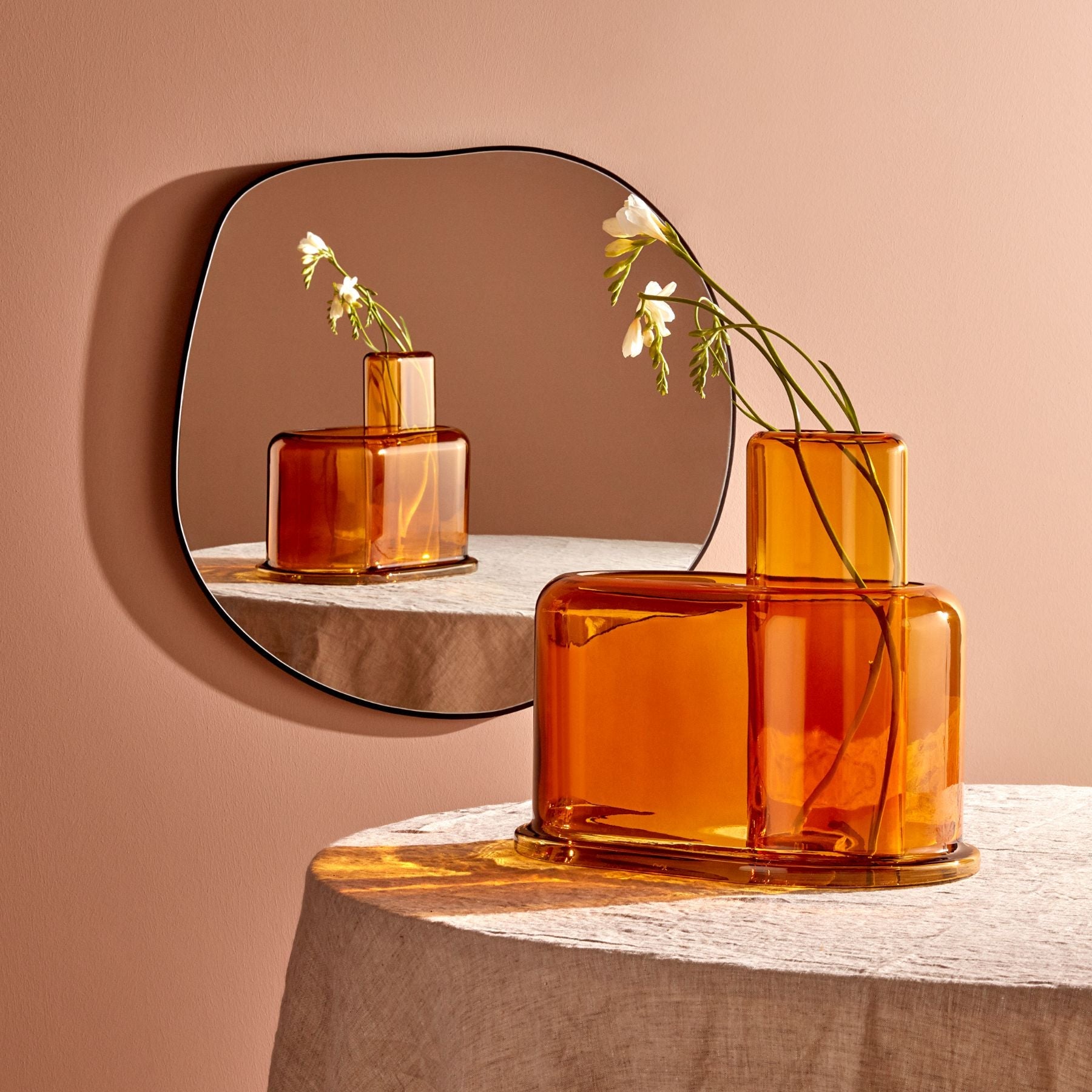 Detailed view of the structured geometric tiers on the glass vase
