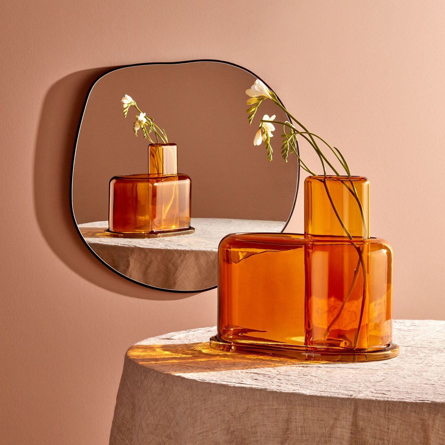 Modern lead-free crystal vase reflecting natural light on a minimalist table.