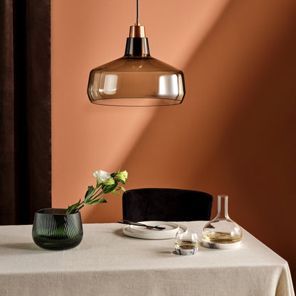 Artistic composition of the crystal carafe with geometric marble bases reflecting soft light.