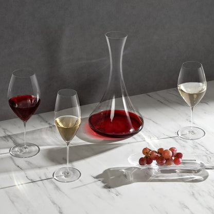 A curated collection of NUDE Stem Zero glassware arranged on a minimalist surface.
