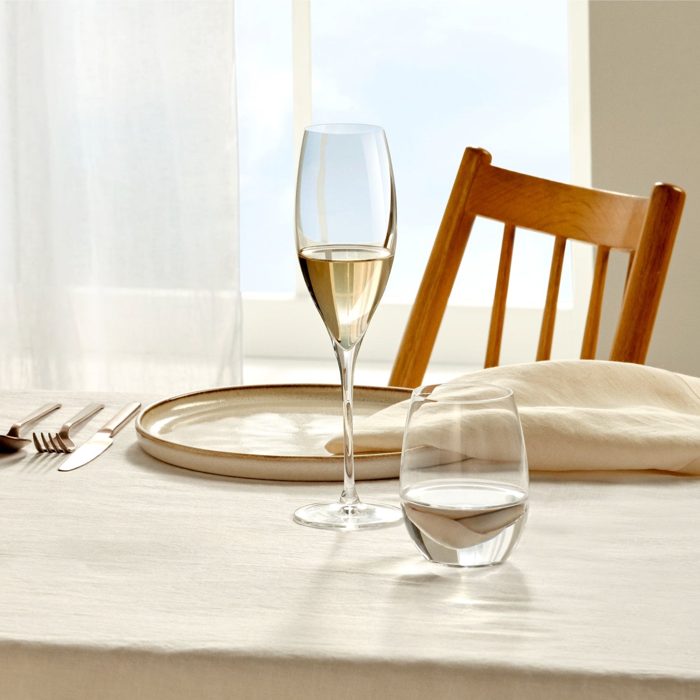 Minimalist tablescape featuring the elegant NUDE Terroir crystal sparkling wine glasses.