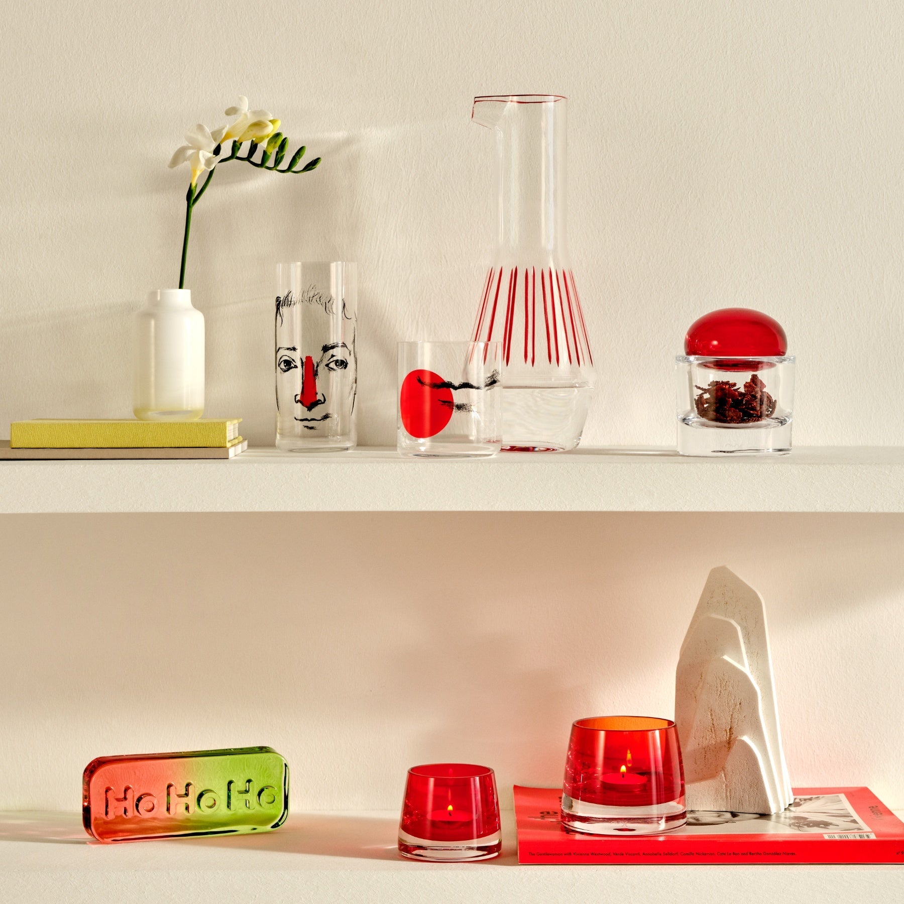 A pair of contemporary glass vases arranged together on a polished surface.