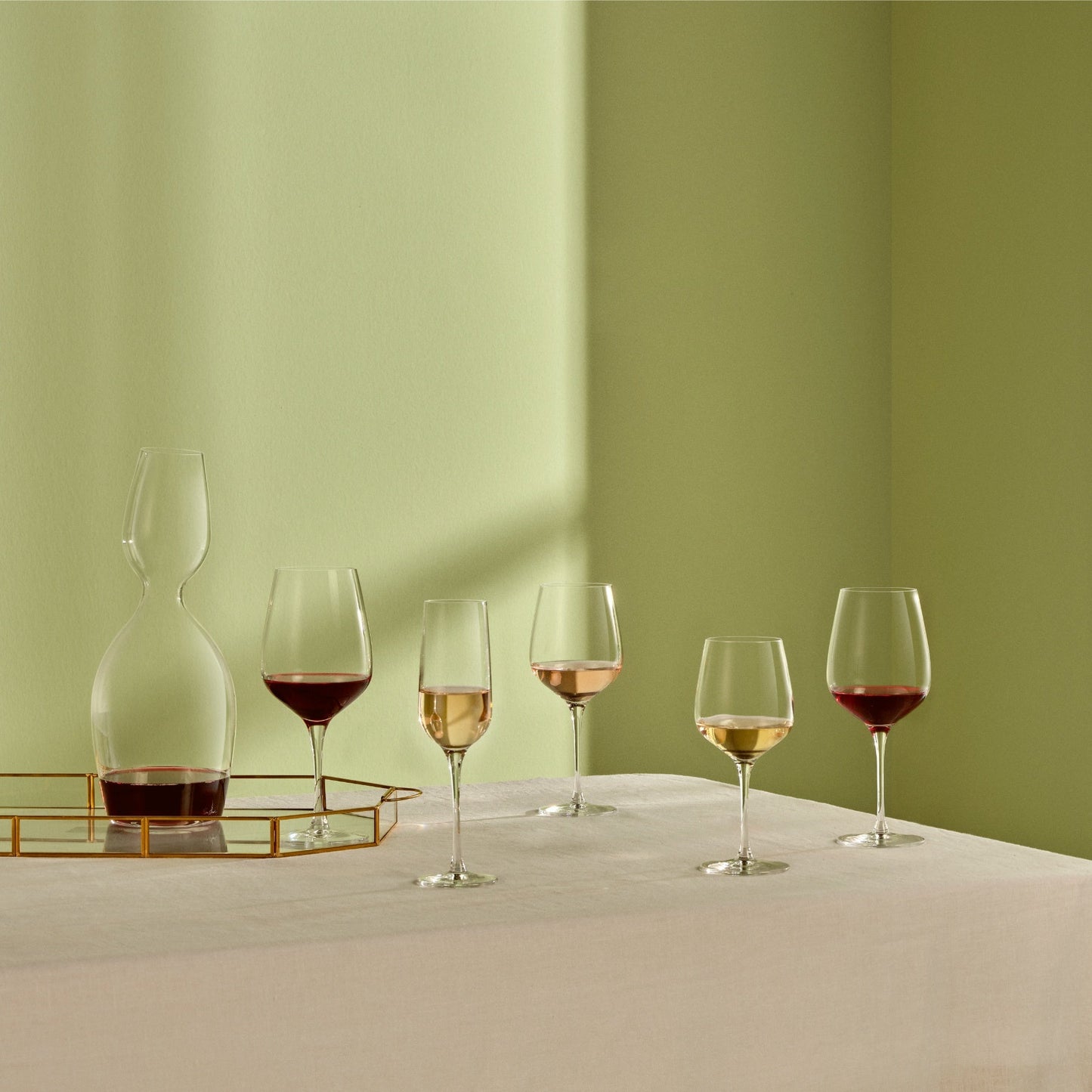 Set of two modern NUDE Glass Refine crystal white wine glasses displayed together on a minimalist surface.