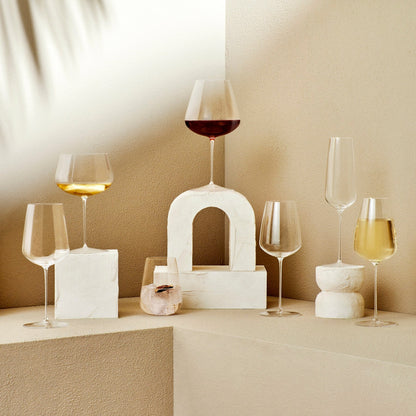 Stylized lifestyle scene with the Stem Zero crystal wine glass catching soft light on a modern surface.
