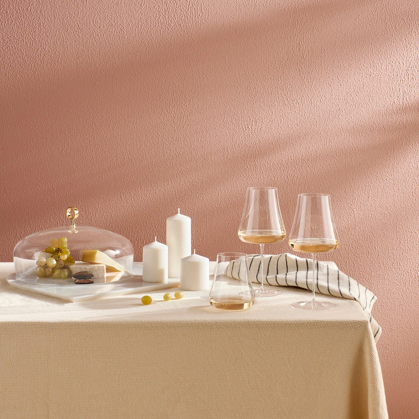 Elegant dining tabletop setting featuring the NUDE Glass Stem Zero Volcano glassware.