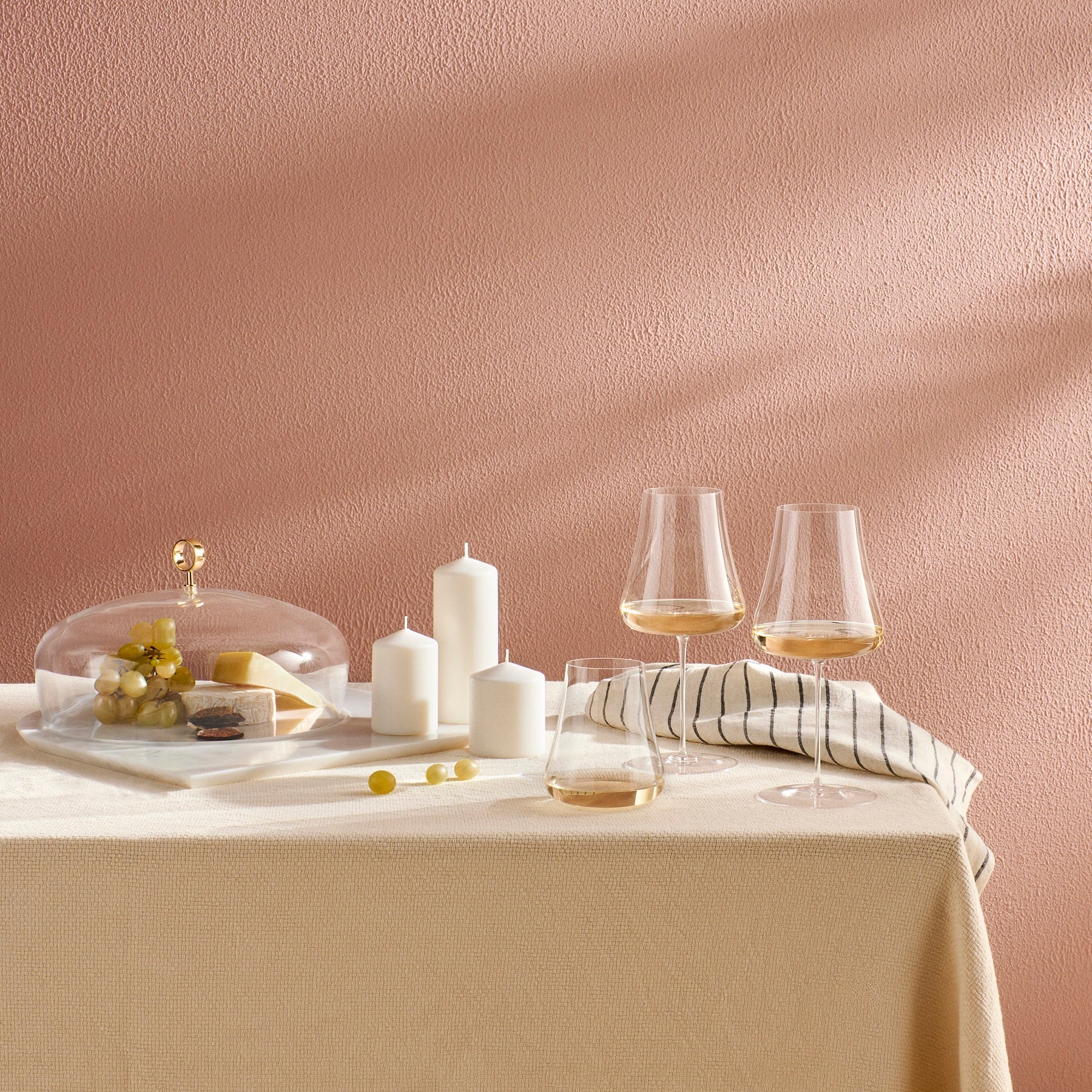 Elegant dining tabletop setting featuring the NUDE Glass Stem Zero Volcano glassware.