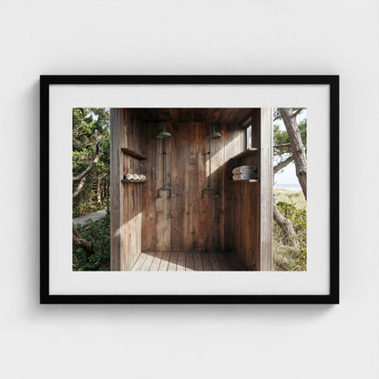 Pines Outdoor Shower framed art print in a 24x18 black landscape wooden frame on a gallery wall.