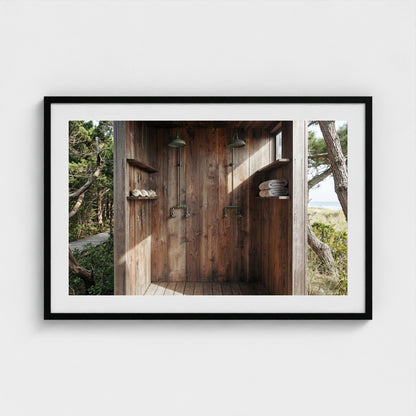 Pines Outdoor Shower framed art print in a 36x24 black landscape frame, styled in a modern interior.