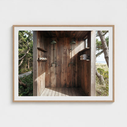 Large scale Pines Outdoor Shower print in a 48x36 natural wood landscape frame in a modern dining room.