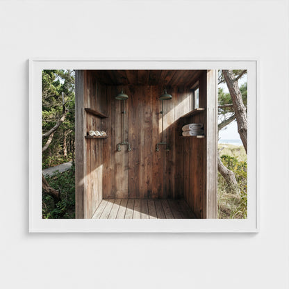Large scale Pines Outdoor Shower print in a 48x36 white wood landscape frame styled in a sunlit bedroom.