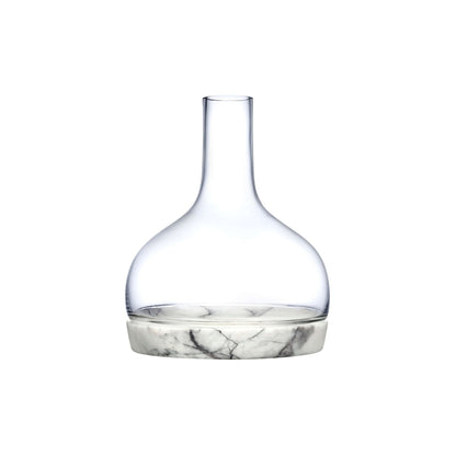 Modern lead-free crystal carafe resting inside a contoured solid marble chilling base.