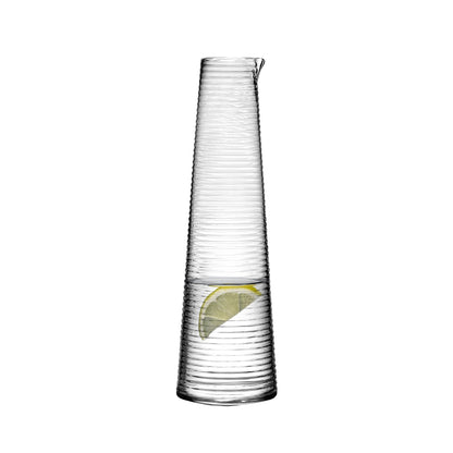 Sleek lead-free crystalline glass carafe highlighting its sculptural silhouette.