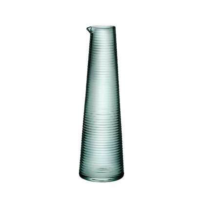 NUDE Glass Poem crystalline water bottle against a minimalist background.
