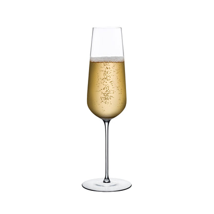 NUDE Stem Zero crystal champagne flute against a minimalist light grey background