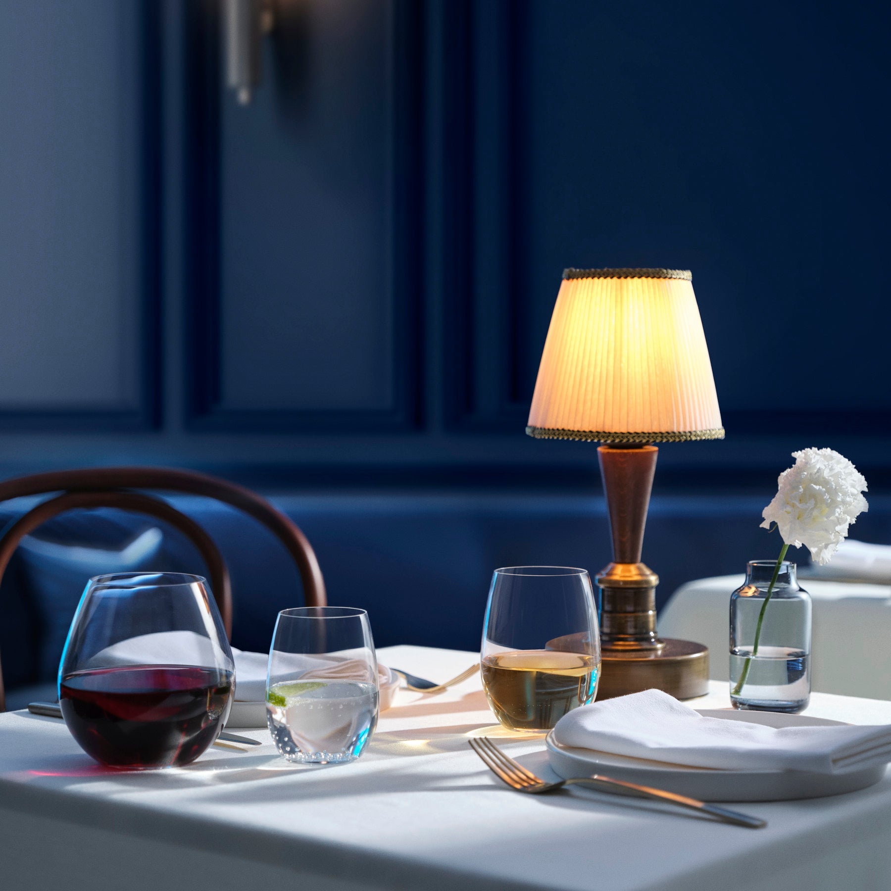 Grouped crystal glassware by NUDE featuring various stemware shapes and a small minimalist vase.
