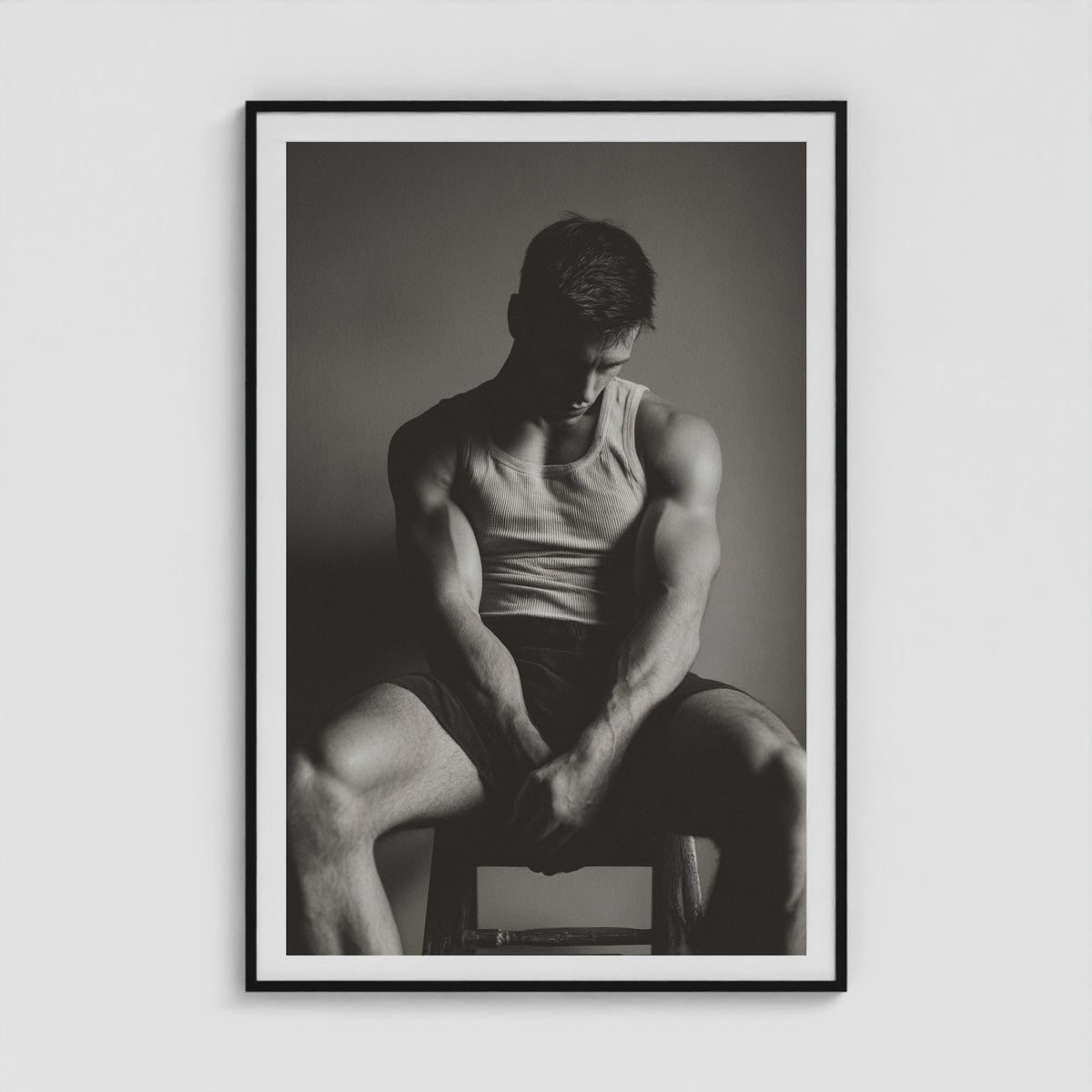 Contemplative male portrait study in denim, presented in a large forty by sixty black box frame.