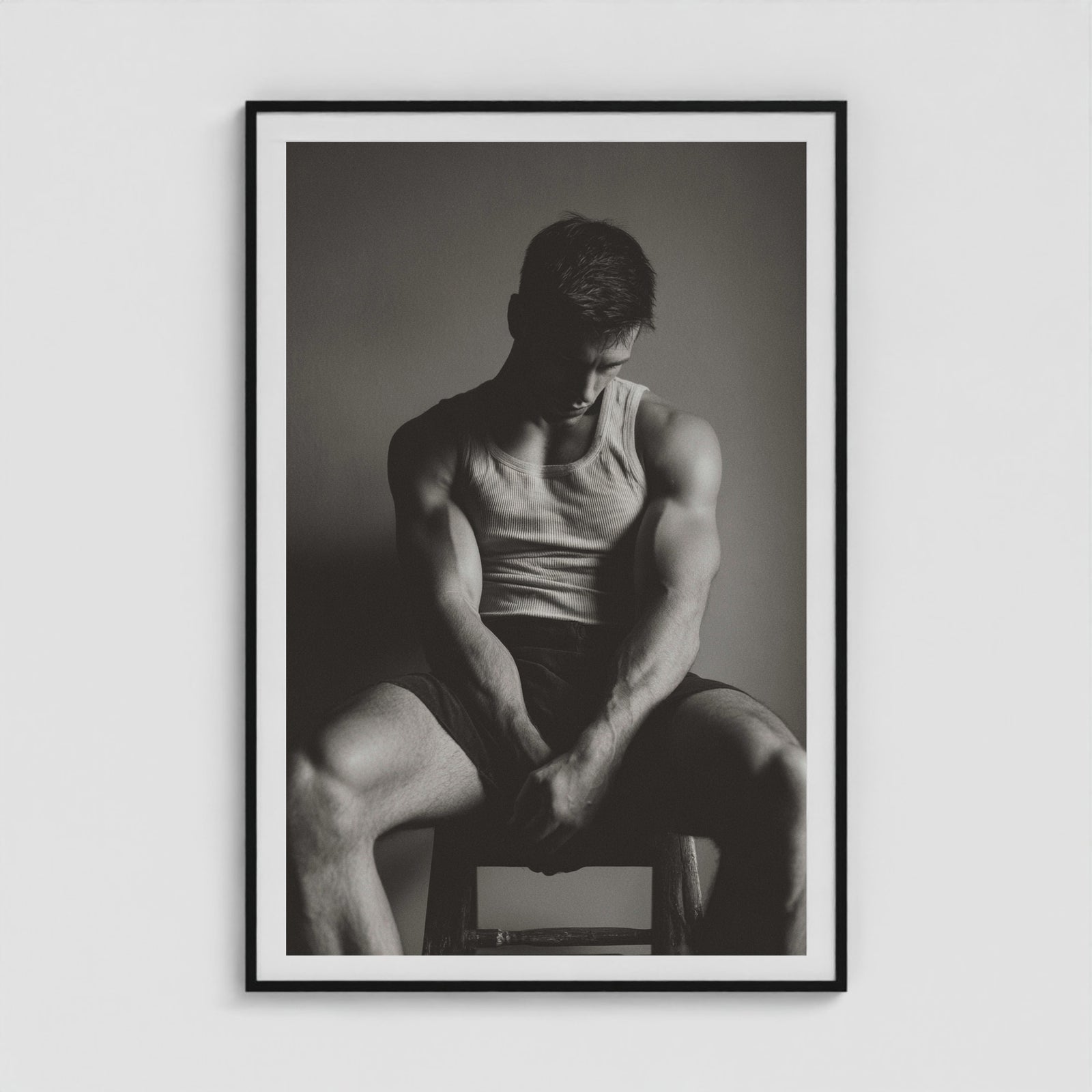Contemplative male portrait study in denim, presented in a large forty by sixty black box frame.
