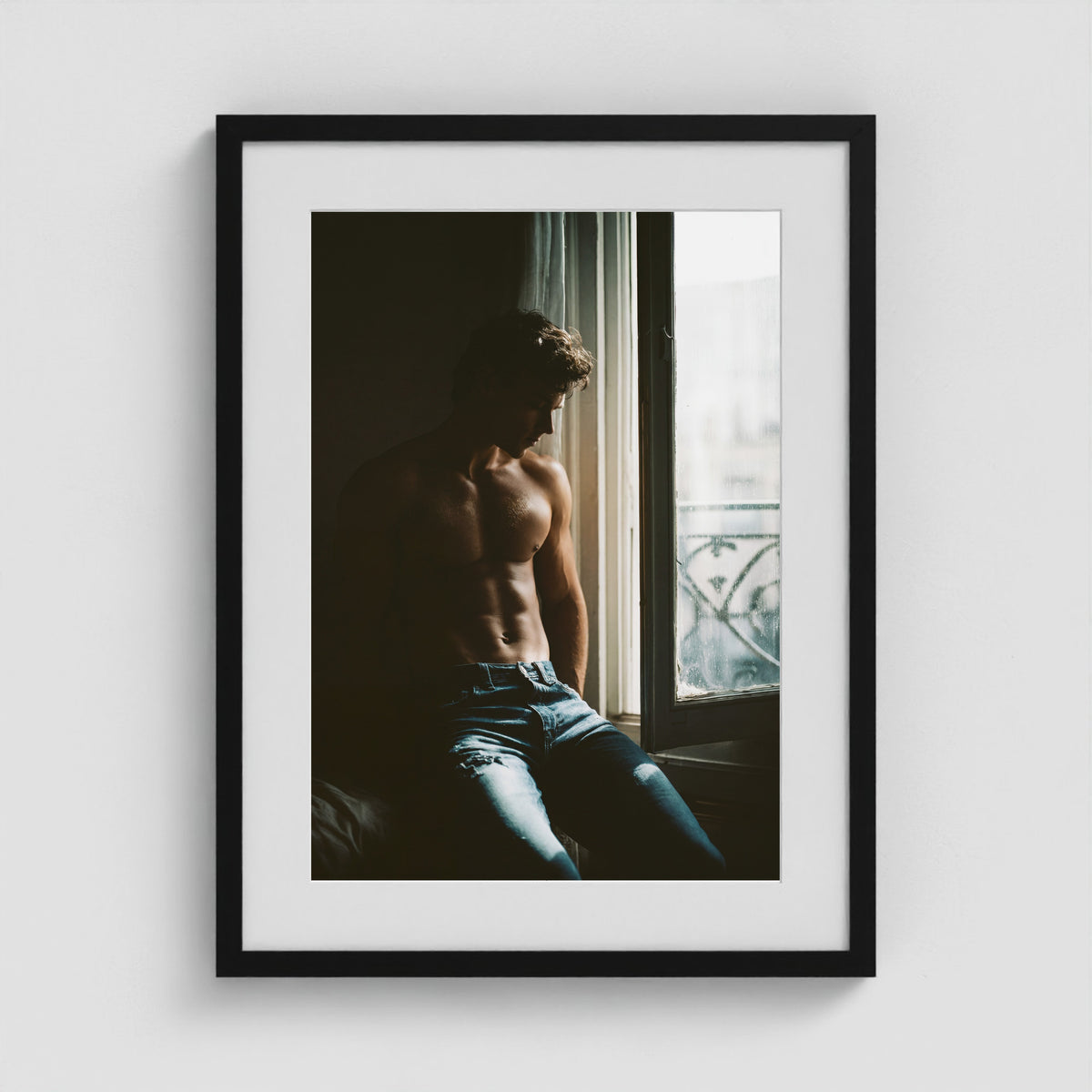 Contemplative window portrait art print in an 18x24 black box frame.