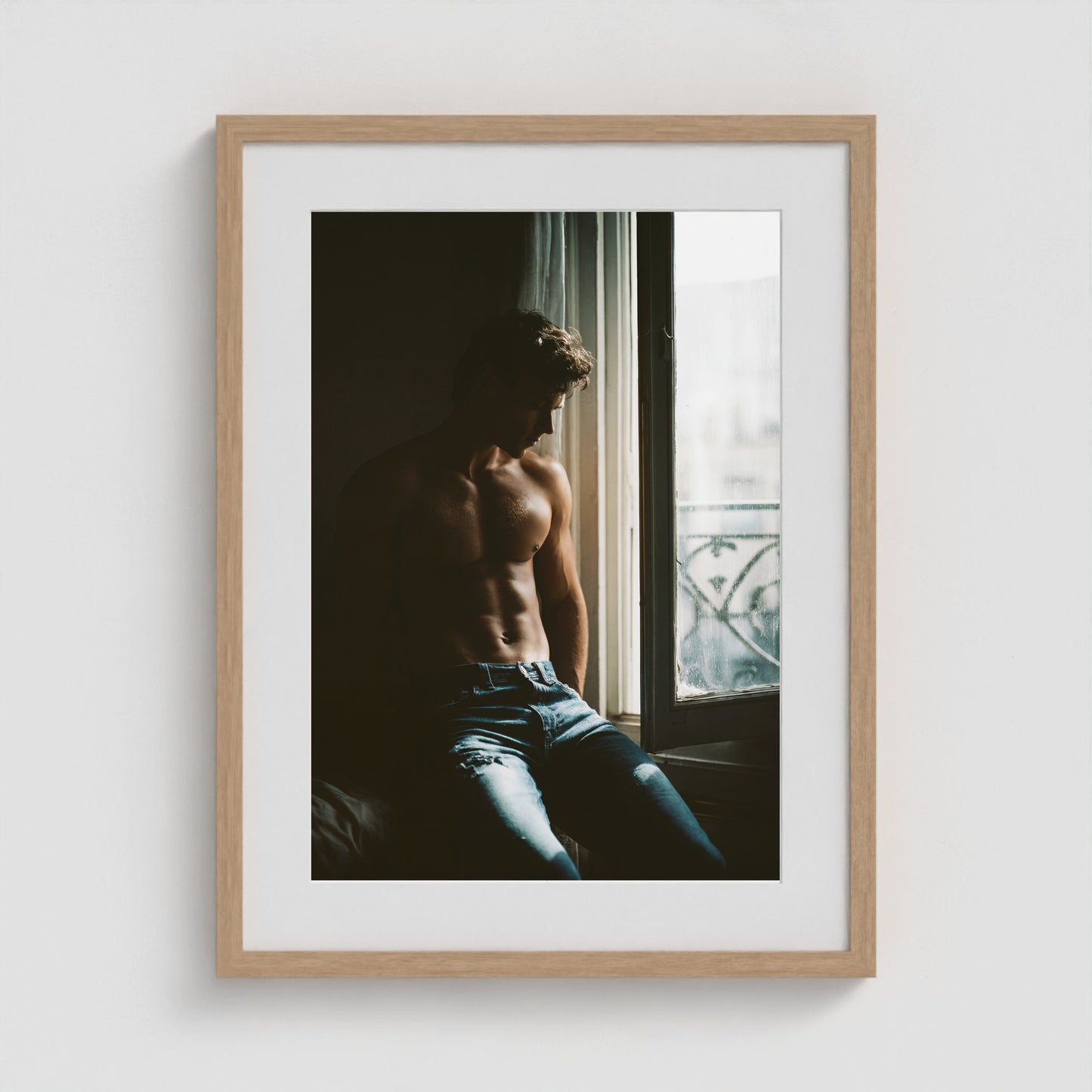 Contemplative window portrait art print in an 18x24 natural oak box frame.