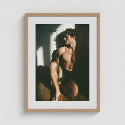 Minimalist male form art print framed in an 18x24 natural wood portrait box frame.