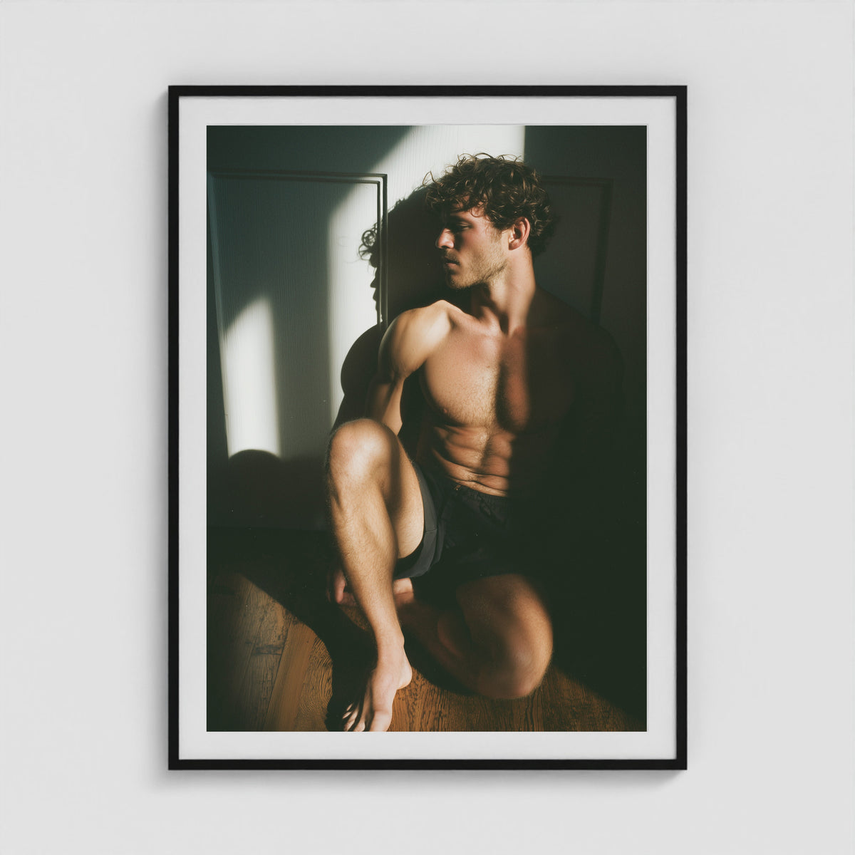 Male figure study in sunlit shadow art print in a 36x48 black portrait box frame.