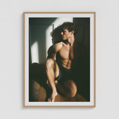 Male figure study in sunlit shadow art print in a 36x48 natural wood portrait box frame.