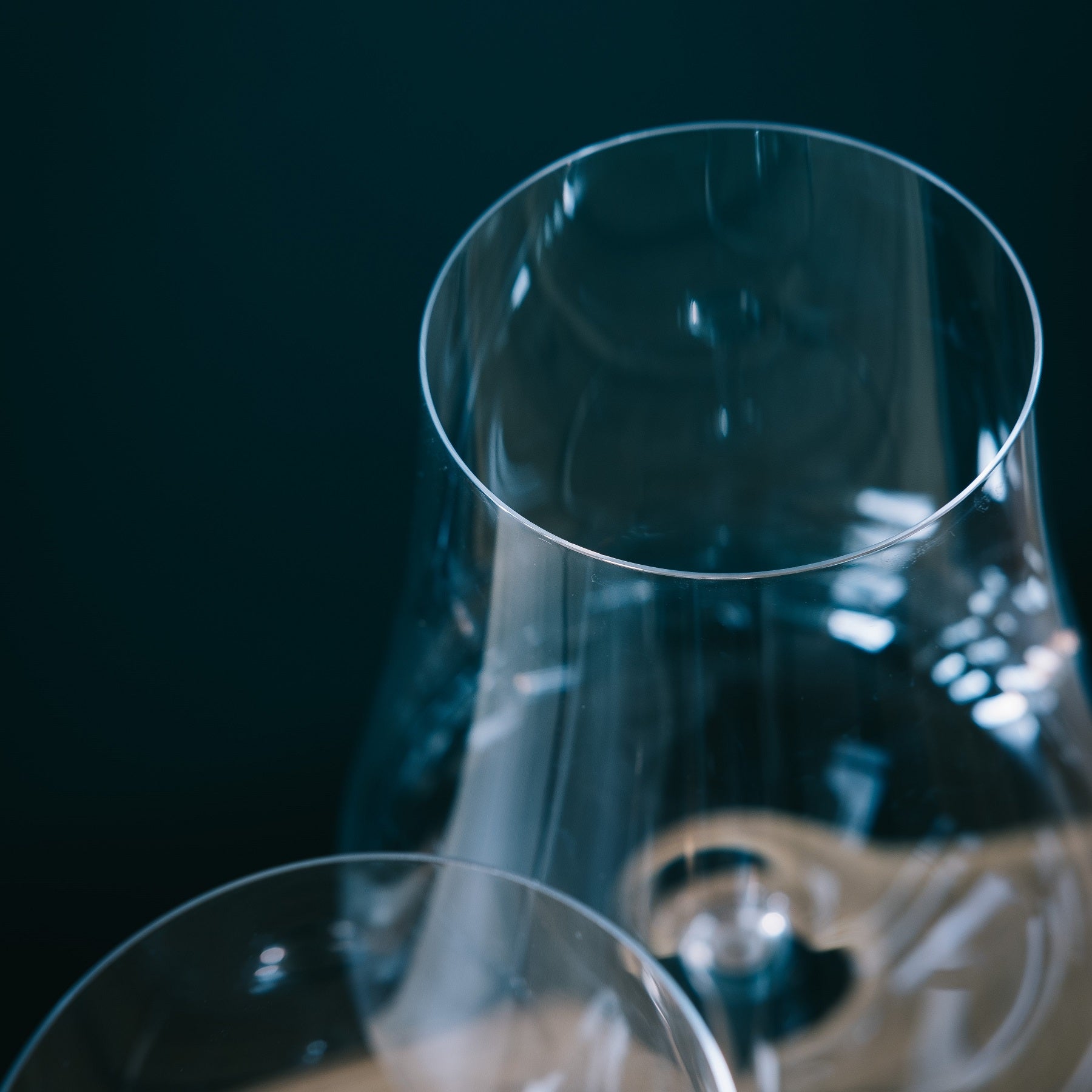 Detailed close-up showing the exceptionally thin rim and elegant curve of a NUDE Glass Stem Zero wine glass.