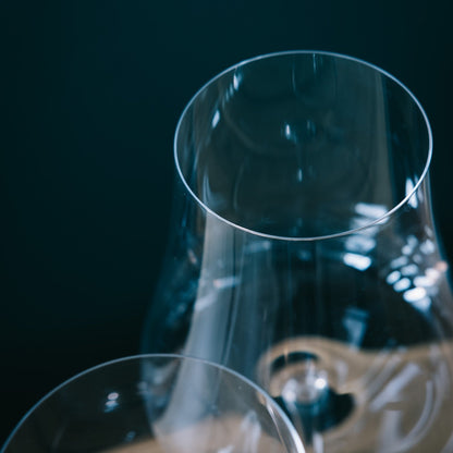 Detailed close-up showing the exceptionally thin rim and elegant curve of a NUDE Glass Stem Zero wine glass.