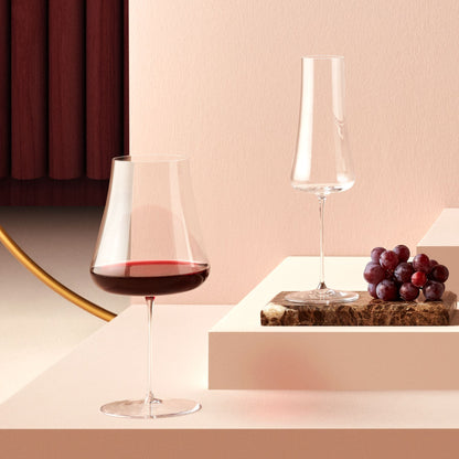 Pair of NUDE Stem Zero Volcano red wine and champagne crystal glasses.