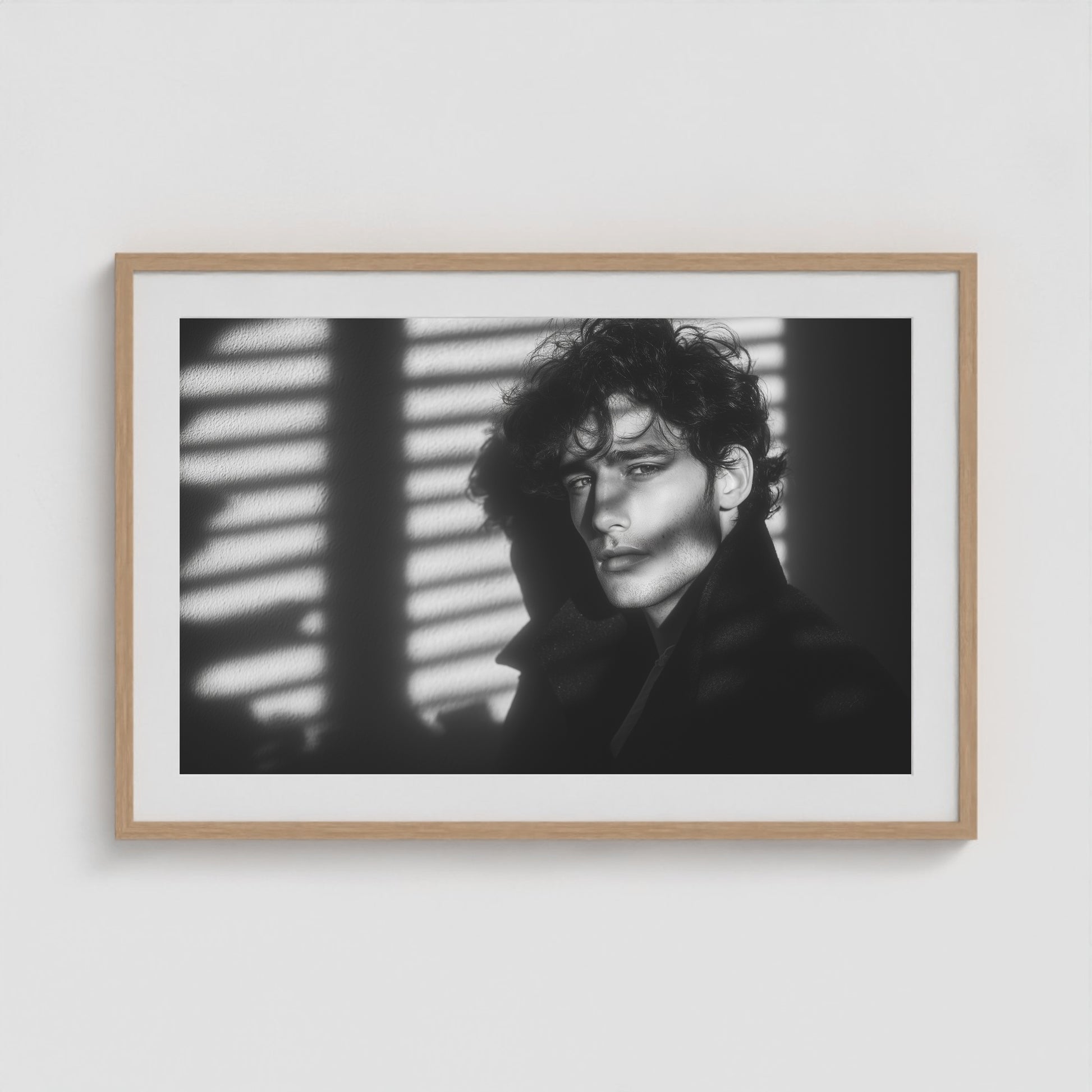 Framed black-and-white male portrait art print in a 36x24 natural wood landscape box frame.