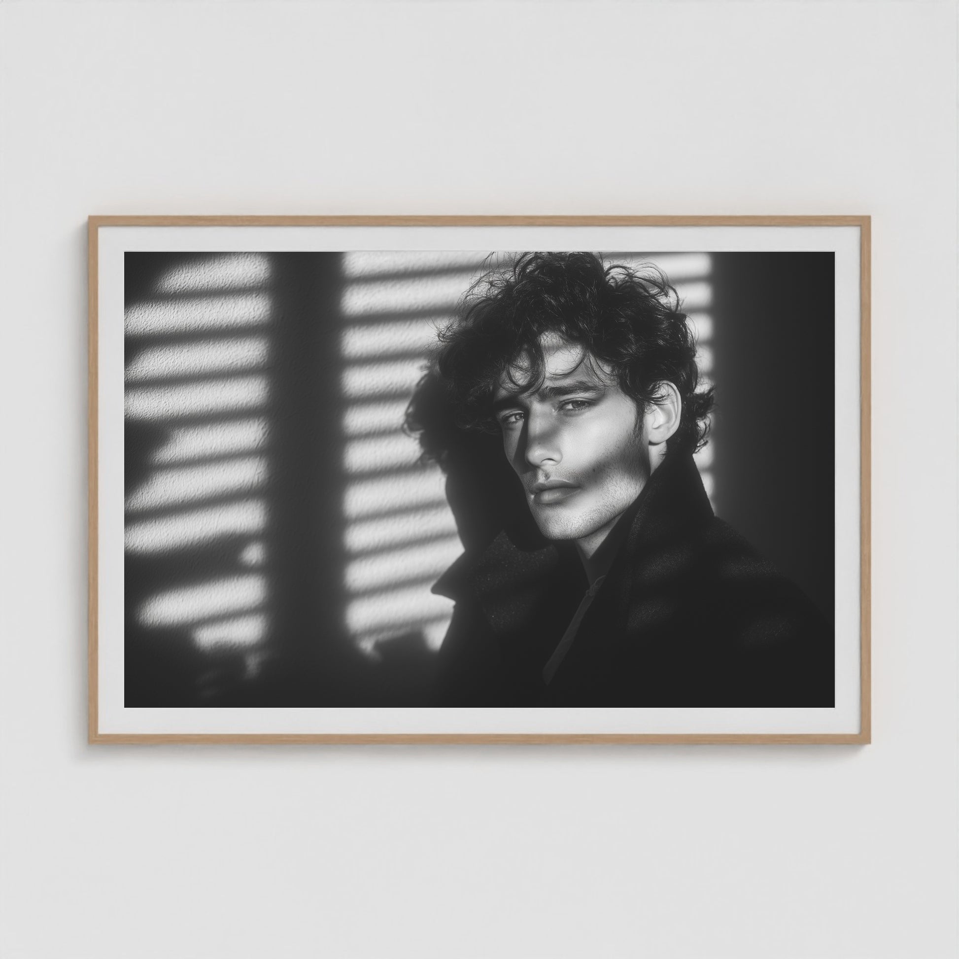 Framed black-and-white male portrait art print in a large 60x40 natural wood landscape box frame.