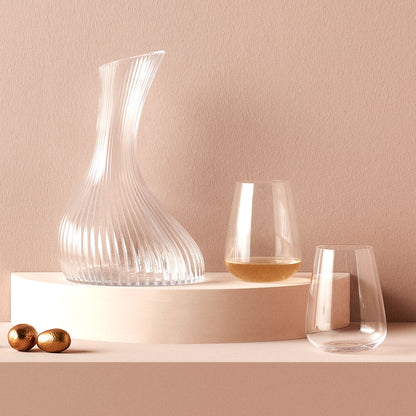 Elegant pairing of a crystal carafe and a Stem Zero water glass on a modern dining surface.