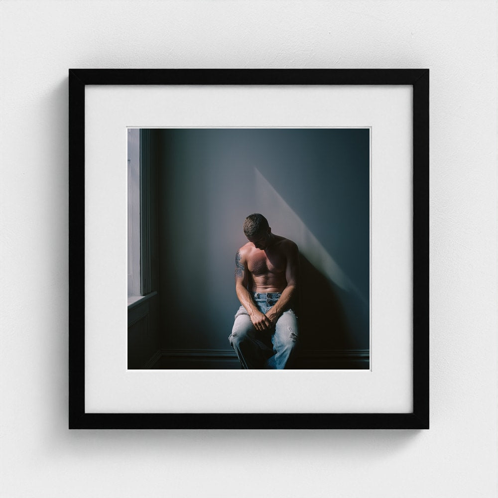 Contemplative Male Portrait Art Print in a 16x16 black square frame