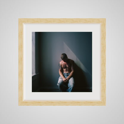 Front view of Contemplative Male Portrait Art Print in a 16x16 deep natural square spacer frame
