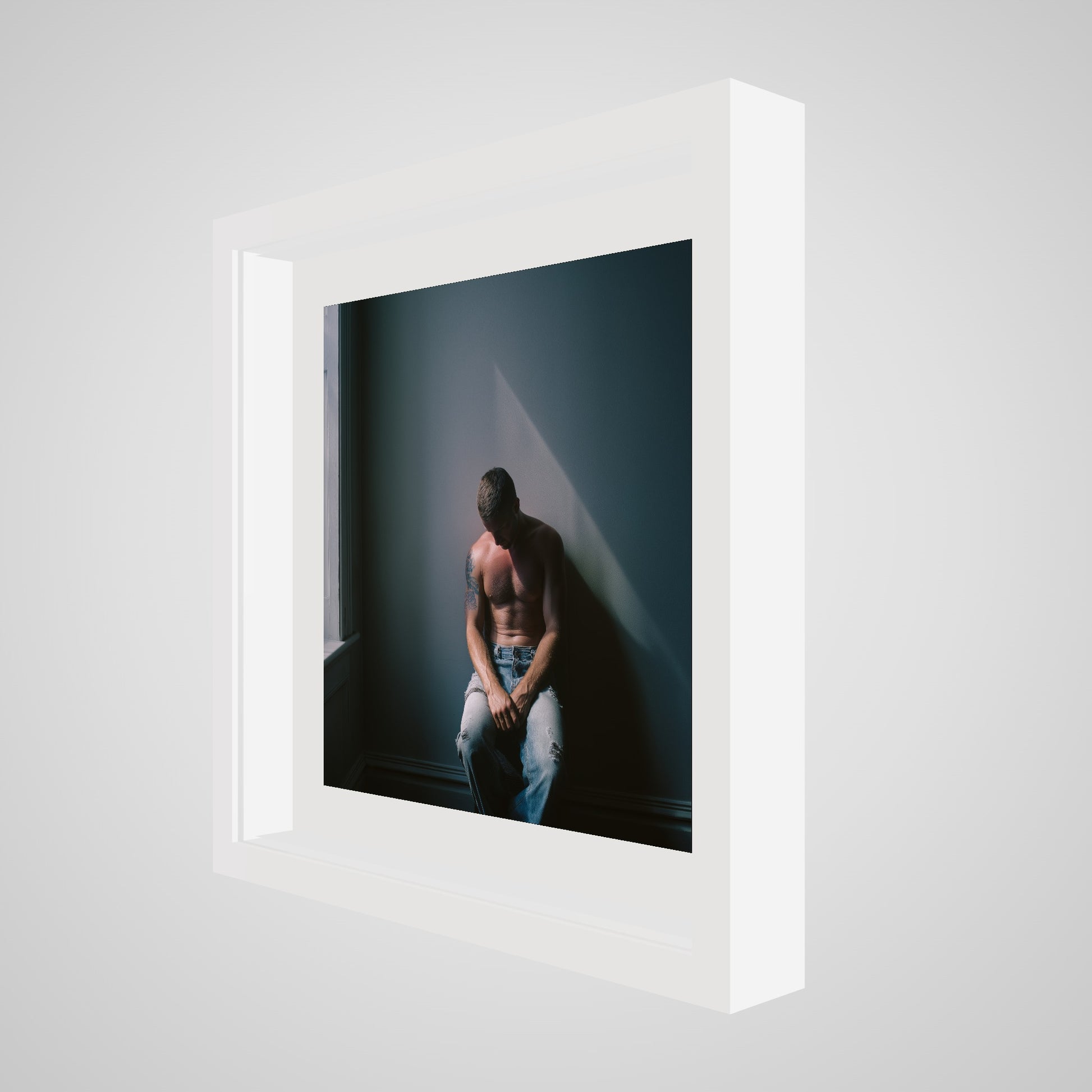 Angled view of Contemplative Male Portrait Art Print in a 16x16 deep white square spacer frame