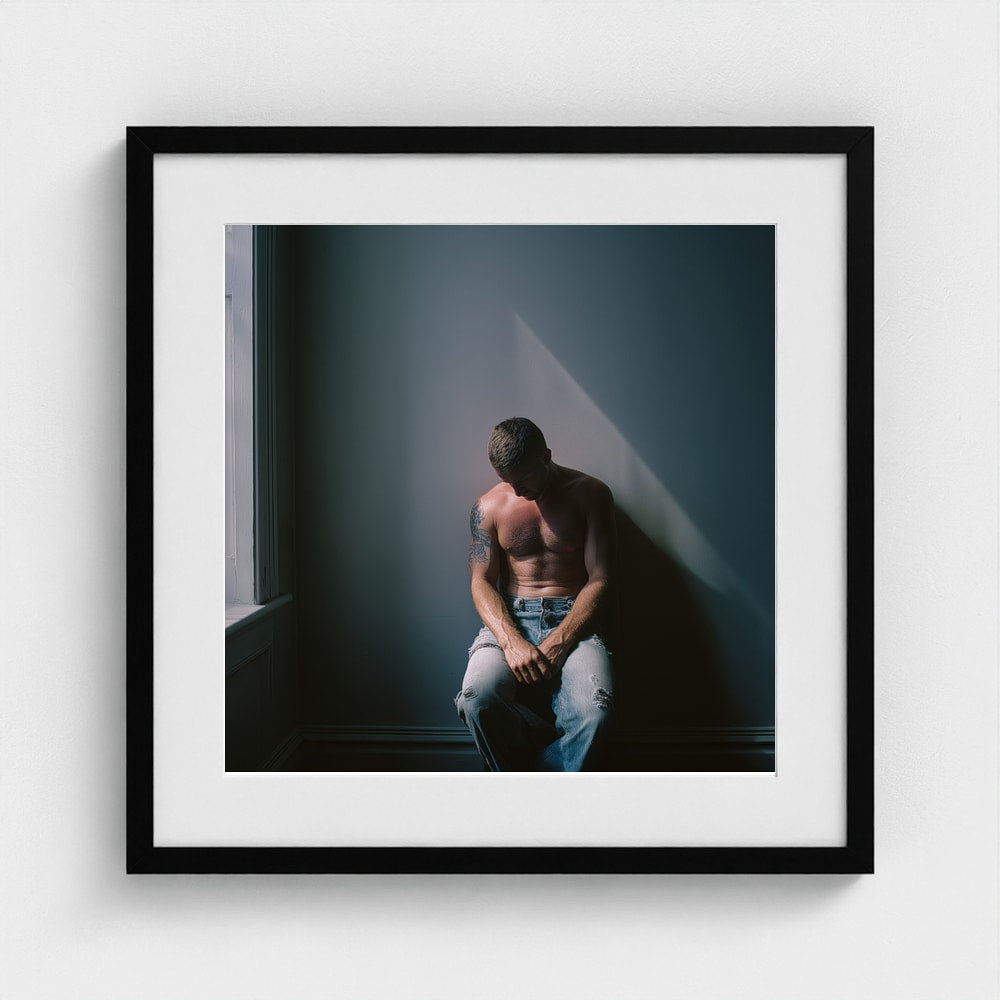 Contemplative Male Portrait Art Print in a 20x20 black square frame