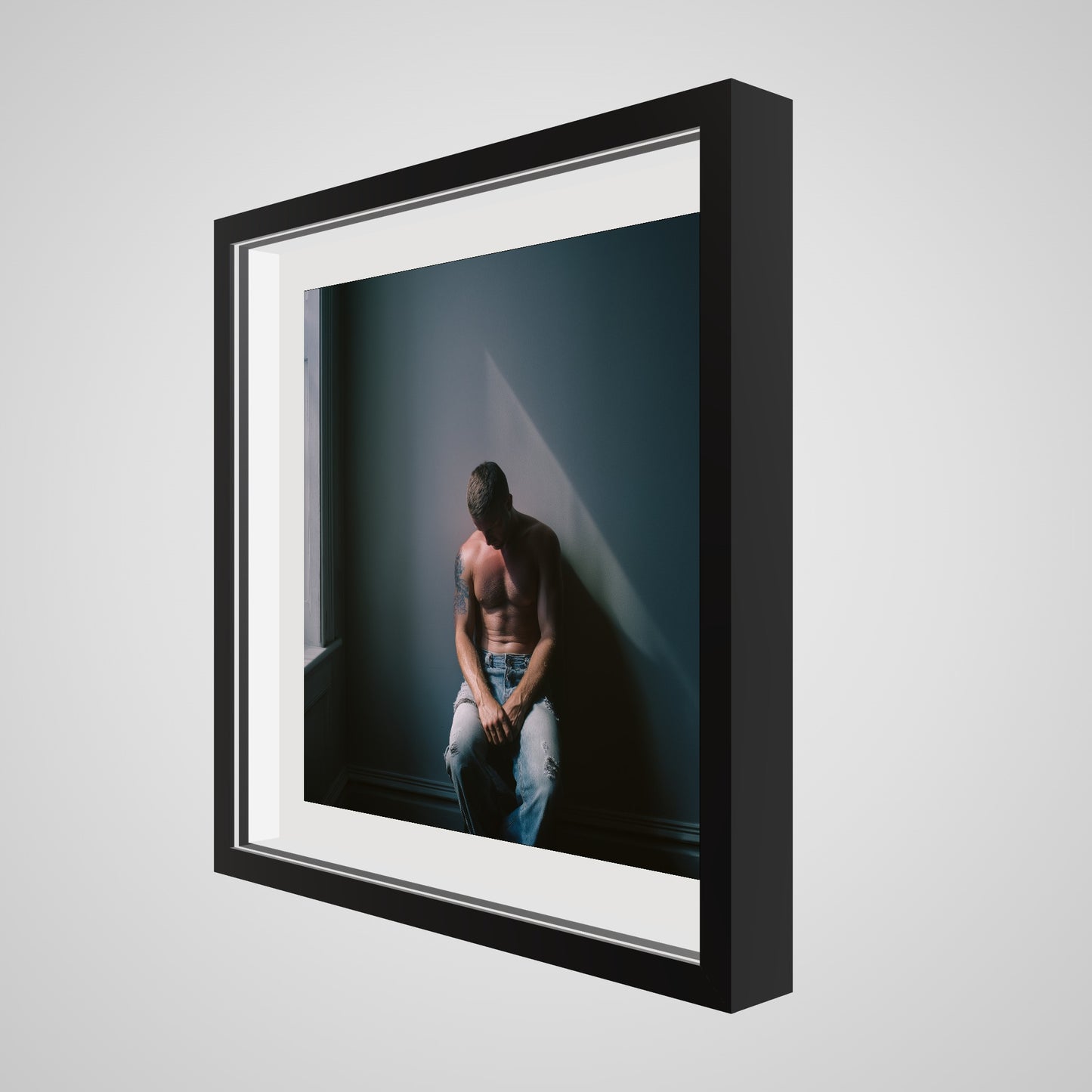 Angled view of Contemplative Male Portrait Art Print in a 20x20 deep black square spacer frame
