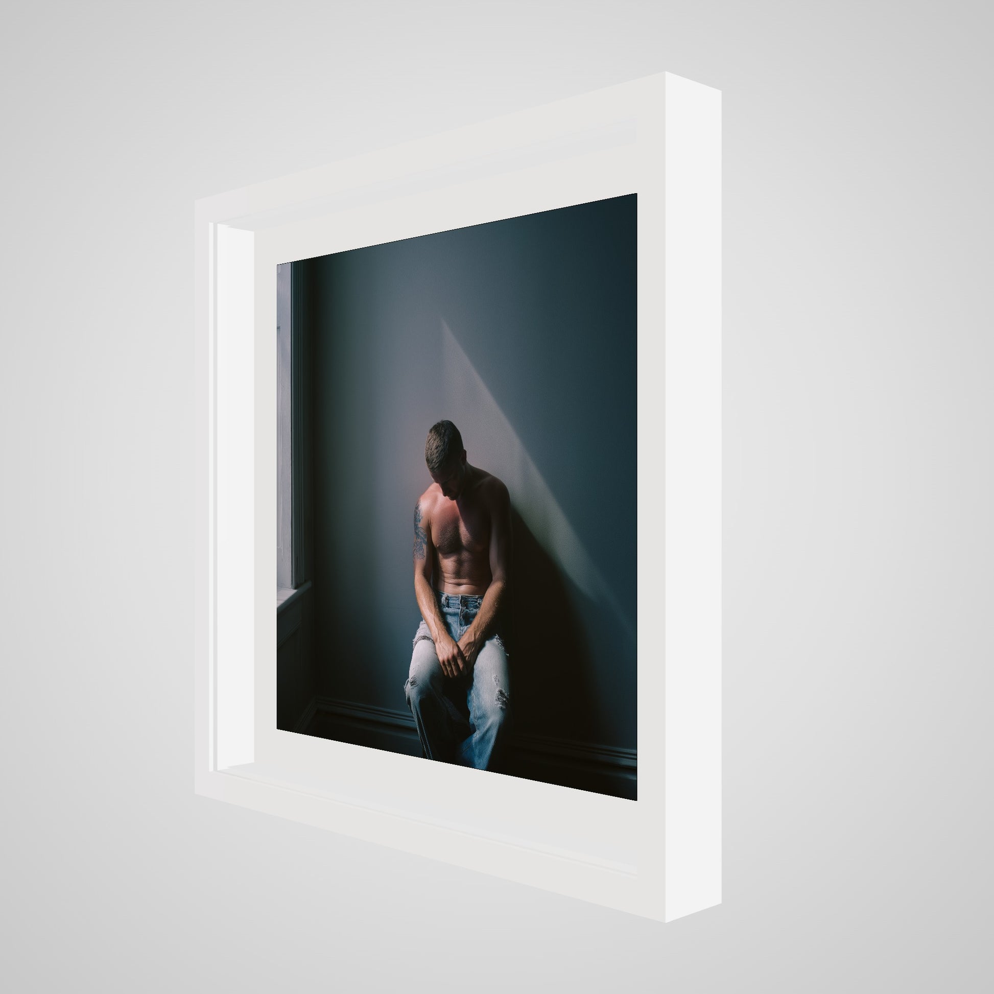 Angled view of Contemplative Male Portrait Art Print in a 20x20 deep white square spacer frame
