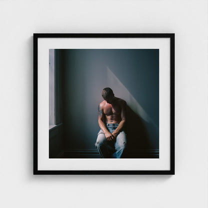Contemplative Male Portrait Art Print in a 24x24 black square frame