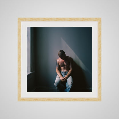 Front view of Contemplative Male Portrait Art Print in a 24x24 deep natural square spacer frame