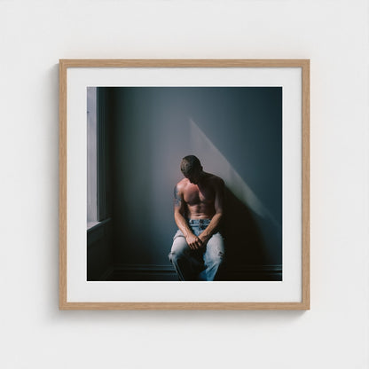 Contemplative Male Portrait Art Print in a 24x24 natural wood square frame